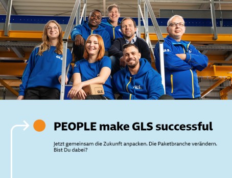 Mehrere Mitarbeitende sitzen lächelnd auf einer Treppe im Depot