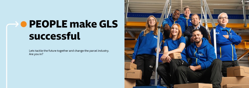 Several employees sit smiling on a staircase in the depot