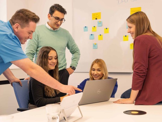 Employees talking to each other in the open office space