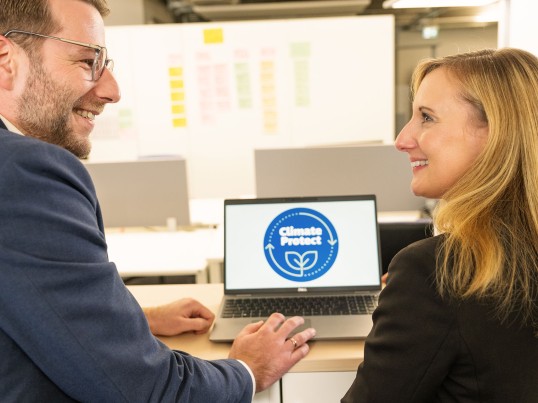 Employees working at a presentation and smiling at each other