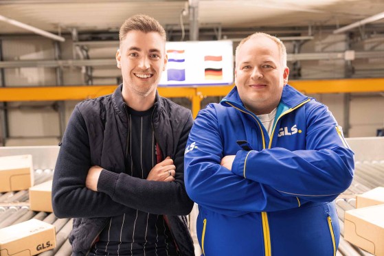 Depot Managers stand with arms crossed and smiling at the camera in the depot