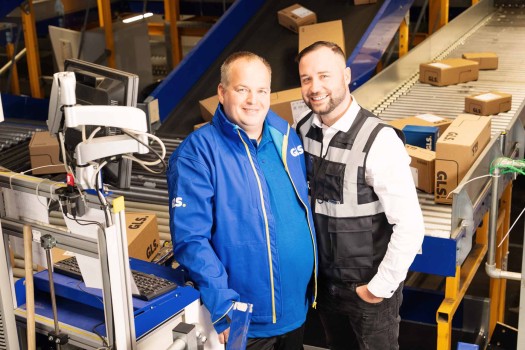 Managers in the depot laugh into the camera