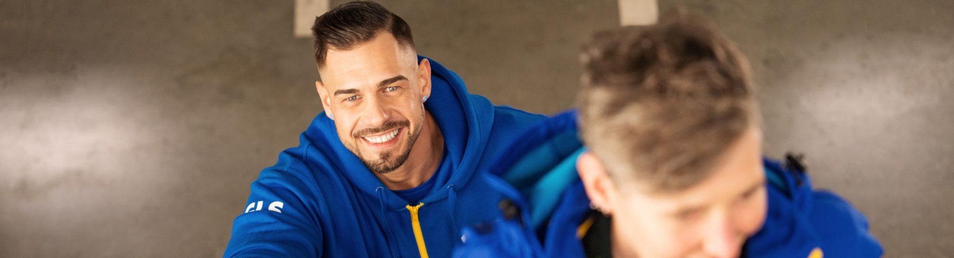 Two employees walk up a flight of stairs together in the hall