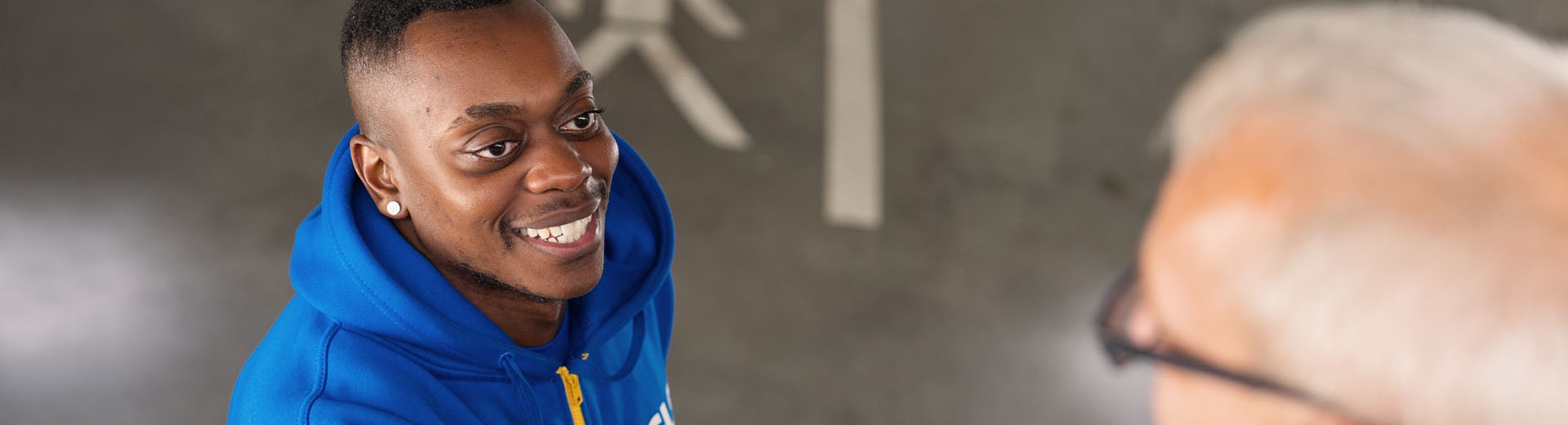 Two employees in the depot shake hands