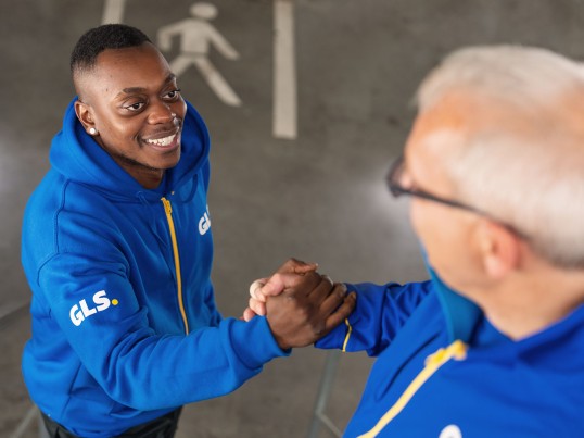 Employee shakes another employees hand