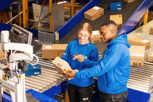 Depot staff scans parcels on the conveyor belt